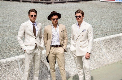 Three men at the melbourne cup race day wearing suits and swanky socks 